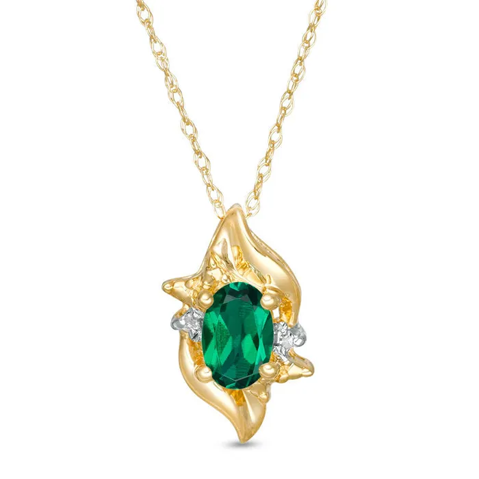Goldia Necklaces Oval LabCreated Emerald and Diamond Accent Flame Burst Pendant in 10K Yellow Gold Goldia Necklaces Oval LabCreated Emerald and Diamond Accent Flame Burst Pendant in 10K Yellow Gold